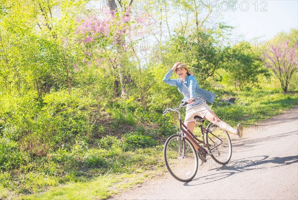 Mid adult woman riding bicycle