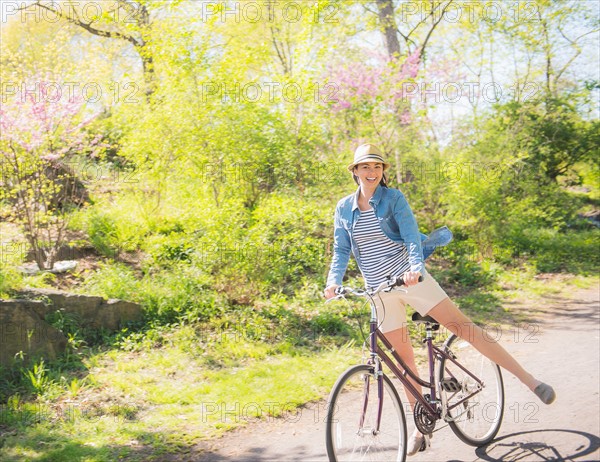 Mid adult woman riding bicycle