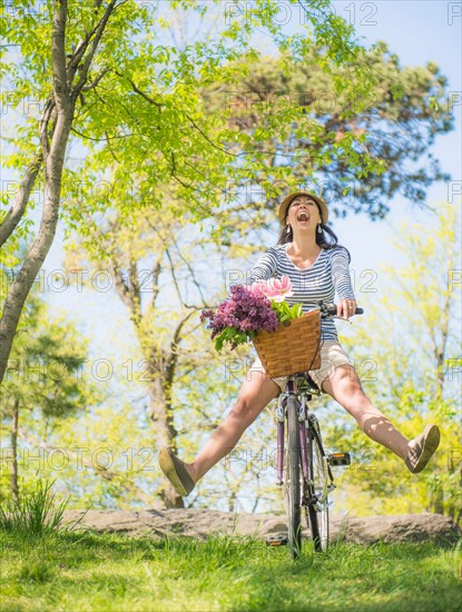 Mid adult woman riding bicycle