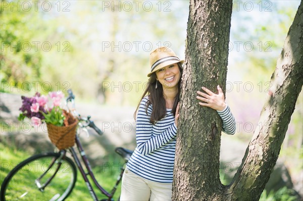 Portrait of mid adult woman embracing tree