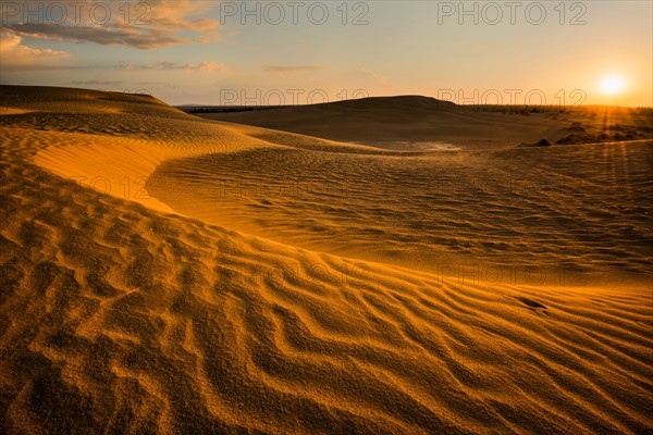 Sunrise over sand dunes