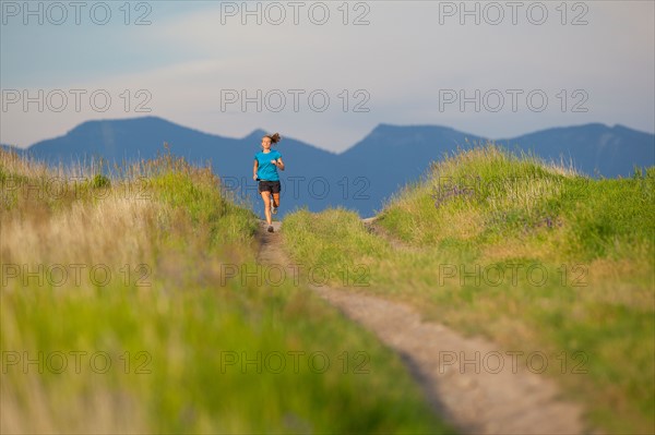 Distant view of young woman jogging