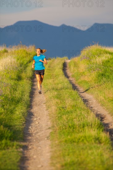 Front view of young woman jogging
