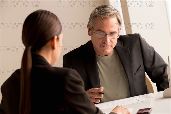 Mature man and woman working together