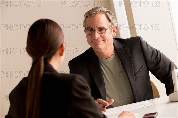 Mature man and woman working together