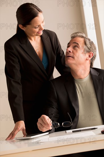 Mature man and woman working together