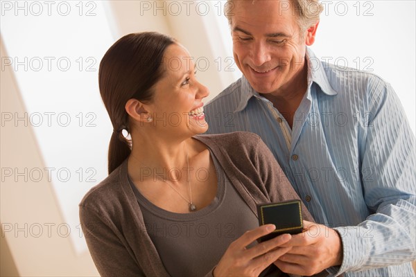 Mature woman holding gift from mature woman