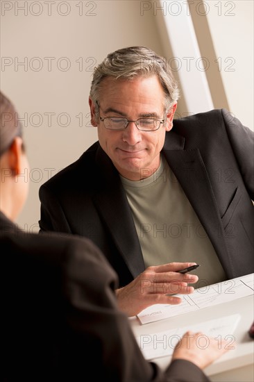 Mature man working with woman