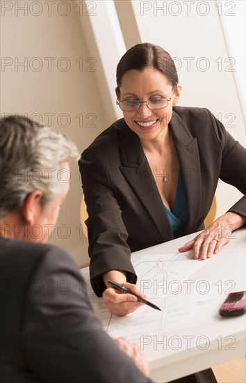 Mature woman working with mature man