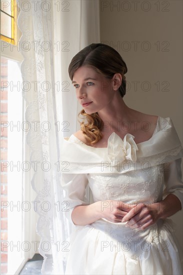 Bride looking out window