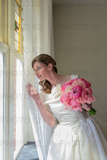 Bride looking out window