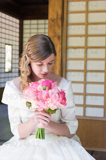 Portrait of bride with bouquet of pink flowers