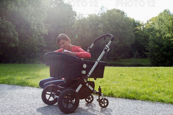 Mother with pram in park