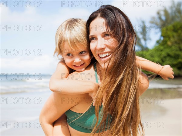 Mother with daughter (2-3) on beach