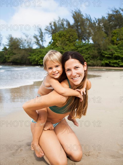 Mother with daughter (2-3) on beach