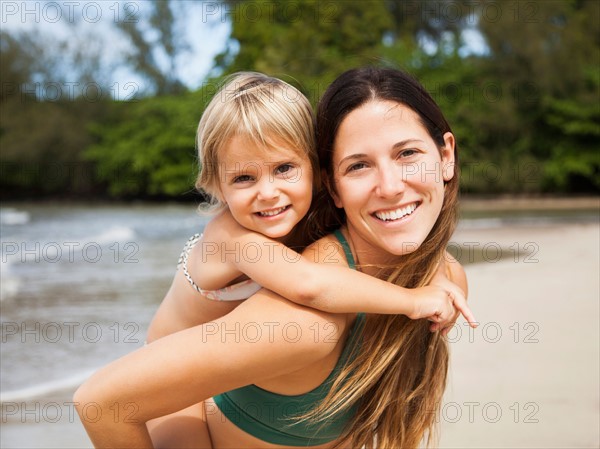 Mother with daughter (2-3) on beach