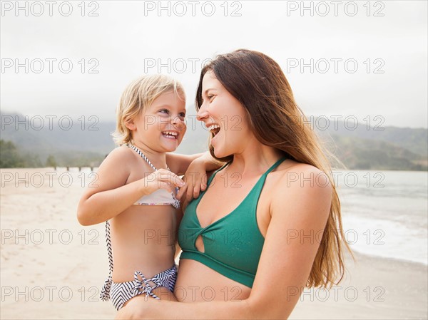 Mother with daughter (2-3) on beach