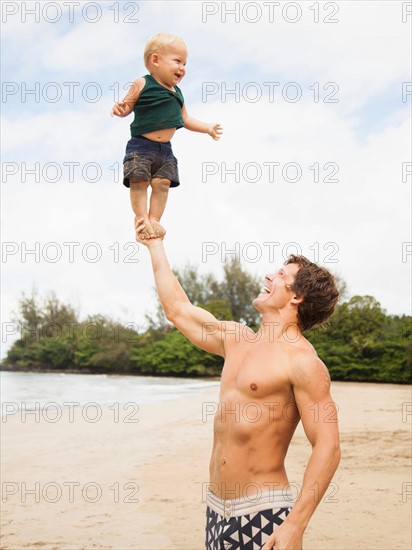 Father with son (6-11 months) on beach