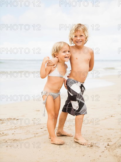 Laughing sibling on beach