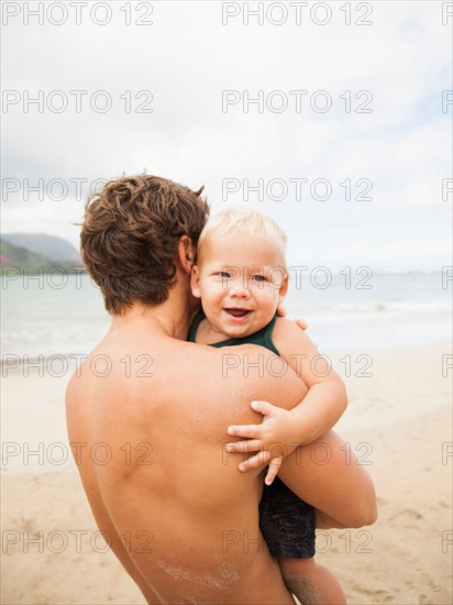 Father with son (6-11 months) on beach