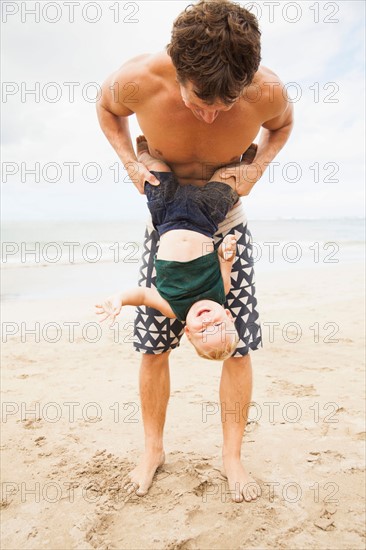 Father with son (6-11 months) on beach