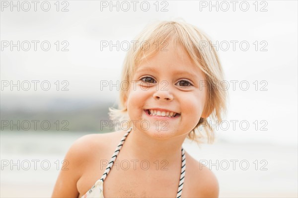 Baby girl (2-3) on beach