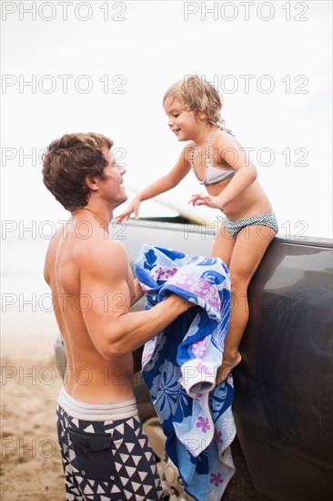 Baby girl (2-3) with father on beach