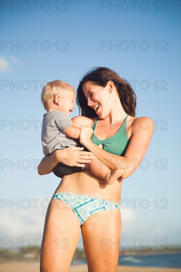 Mother with baby boy (6-11) in arms