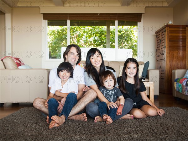 Portrait of family sitting in living room