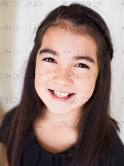 Portrait of girl (8-9) laying on bed