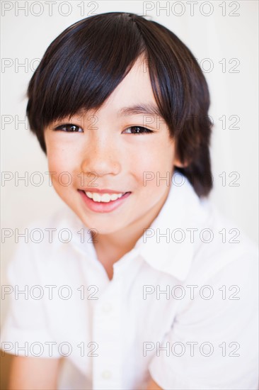 Portrait of boy (8-9) in white shirt