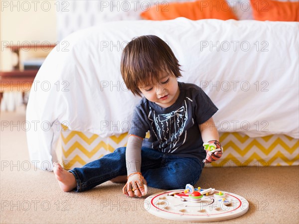 Baby boy (2-3) playing in bedroom