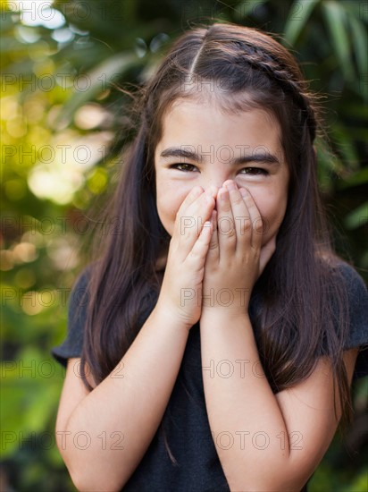 Portrait of girl (8-9) covering mouth