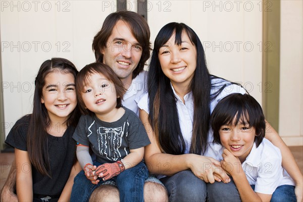 Portrait of family with three kids (2-3, 8-9)