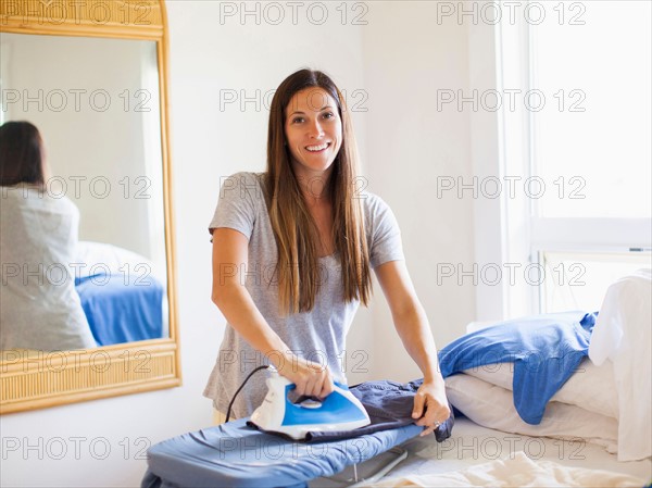 Portrait of woman ironing