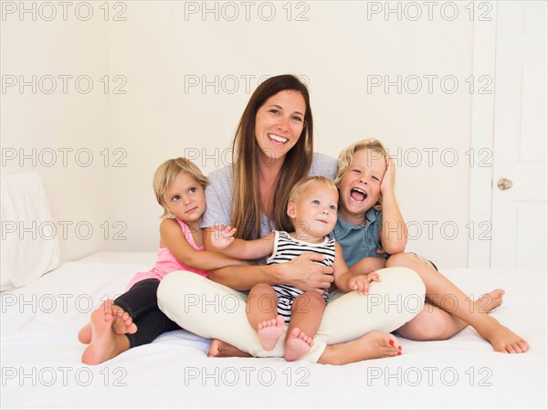 Mother with three kids (6-7, 2-3, 6-11 months)