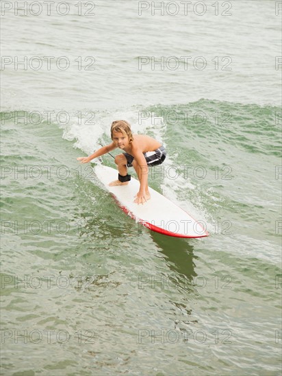 Boy (6-7) surfing