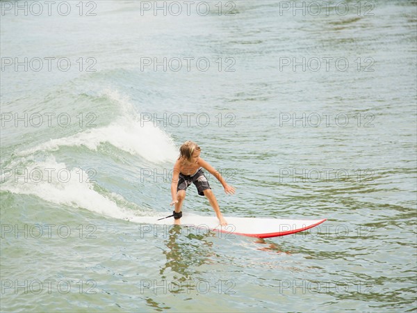 Boy (6-7) surfing