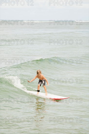 Boy (6-7) surfing