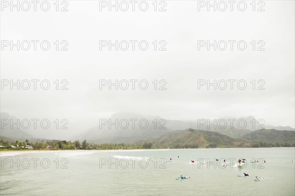 People swimming in bay