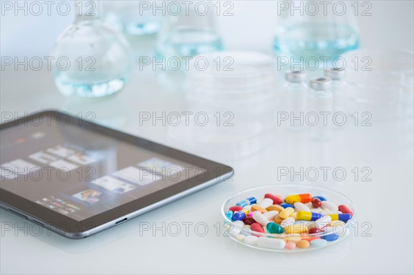 Studio shot of tablet pc and colorful pills.