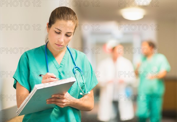 Female doctor in hospital hallway.