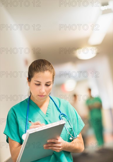 Female doctor in hospital hallway.