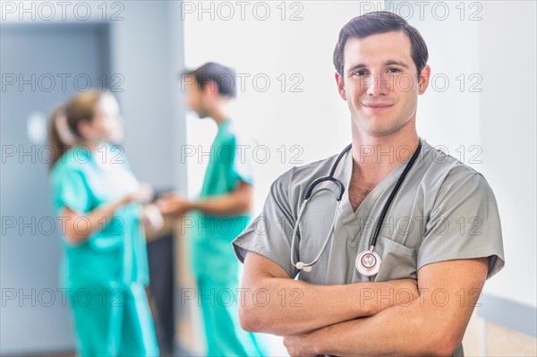 Portrait of male doctor in hospital hallway.