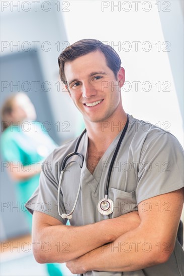 Portrait of male doctor in hospital hallway.