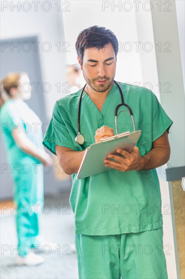 Male doctor in hospital hallway.