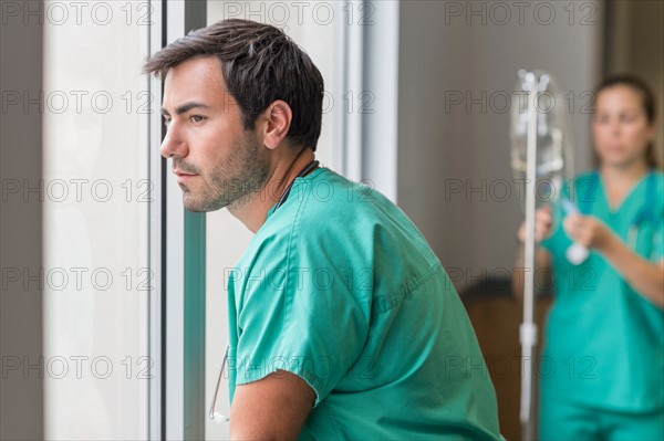 Doctor looking out window.