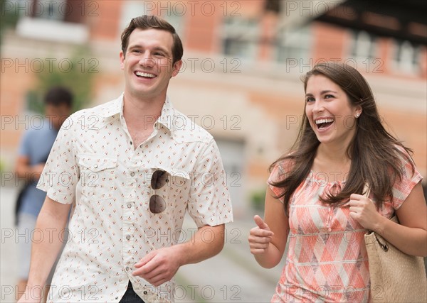 Urban couple laughing.