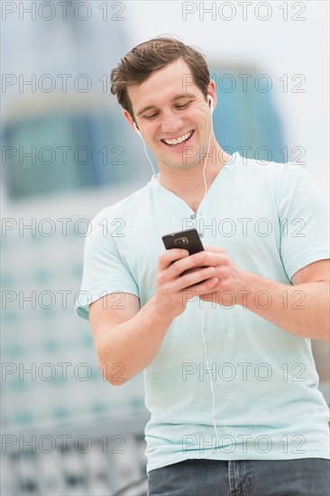 Man listening to music on smartphone.