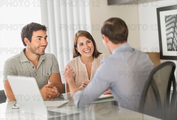 Customers talking to advisor in office.